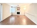 Living room with fireplace and hardwood floors at 3667 Spring Willow Ct, Las Vegas, NV 89147