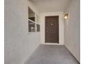 Front entrance with a dark brown door and a small window at 4273 Sun Vista Dr, Las Vegas, NV 89104