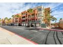 Exterior view of the condominium building with attached garages at 67 E Agate Ave # 202, Las Vegas, NV 89123