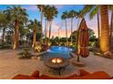 Inviting pool and spa area with fire pit and lounge chairs at 2110 Strada Mia Ct, Las Vegas, NV 89117