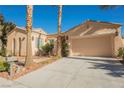 Single-story house with a landscaped yard, driveway, and a two-car garage at 2824 Evening Rock St, Las Vegas, NV 89135