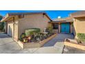 Close-up view of the home's entryway, highlighting the teal double doors and desert landscaping at 3216 Burton Ave, Las Vegas, NV 89102