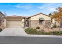 Single-story home with stone accents and a two-car garage at 7738 Comanche Canyon Ave, Las Vegas, NV 89113