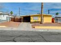 Bright yellow ranch house with a carport and mature palm tree at 1020 Nassau Dr, Las Vegas, NV 89108