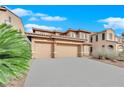 Two-story house with three-car garage and desert landscaping at 4028 Kristina Lynn Ave, North Las Vegas, NV 89081