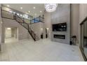 Two-story living room with fireplace and high ceilings at 445 Rosina Vista St, Las Vegas, NV 89138