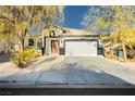 Single story home with a two-car garage and landscaped front yard at 1176 Colgate Ln, Las Vegas, NV 89110