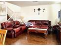 Living room with hardwood floors and leather furniture at 5384 Hanging Tree Ln, Las Vegas, NV 89118