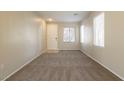 Carpeted living room with neutral walls and several windows at 2517 Madre Grande St, Las Vegas, NV 89142