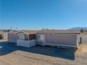 Manufactured home with covered porch and large windows, mountain views at 3581 W Dyer Rd, Pahrump, NV 89048