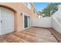 Small patio with brown tile flooring and a white block wall at 8405 Sewards Bluff Ave, Las Vegas, NV 89129