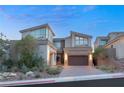 Contemporary home with a two-car garage and landscaped front yard at 31 Vista Outlook St, Henderson, NV 89011