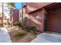 Exterior view of condo building entrance with walkway and landscaping at 4050 Pacific Harbors Dr # 134, Las Vegas, NV 89121