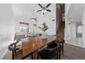 Open dining area with a wood table and modern chairs at 6564 Sweetzer Way, Las Vegas, NV 89108