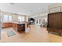 Open concept kitchen with island, hardwood floors, and views to living room at 6717 Journey Hills Ct, North Las Vegas, NV 89084