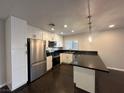 Modern kitchen featuring white shaker cabinets and dark countertops at , Henderson, NV 89002