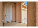 Front entry with tiled flooring, neutral-toned walls, and a view of the garage at 11045 Village Ridge Ln, Las Vegas, NV 89135