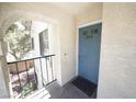 View of a blue front door of a condo unit from the outdoor walkway at 4878 Nara Vista Way # 203, Las Vegas, NV 89103