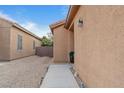 Side view of the house showing a walkway and gravel landscaping at 6061 Moonlight Sonata Ave, Las Vegas, NV 89122