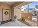 Front entry with a decorative security door and a small landscaped area at 9113 Sea Mink Ave, Las Vegas, NV 89149