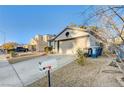 House exterior with a driveway, mailbox, and landscaping at 1690 Autumn Rust Dr, Las Vegas, NV 89119