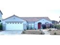 Single-story house with attached garage and red door at 186 Regal Sunset Ave, Henderson, NV 89002