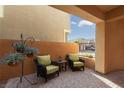 Private patio area with seating and hanging plants at 2070 Morro Vista Dr, Las Vegas, NV 89135