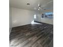 Bright living room with grey wood-look floors and white walls at 148 W Victory Rd, Henderson, NV 89015