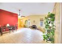 Open living room and dining area with fireplace and ceiling fan at 2256 Sabroso St, Las Vegas, NV 89156