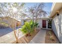 Front entry with a paved walkway, palm trees, and a dark wood door at 5721 Eugene Ave, Las Vegas, NV 89108