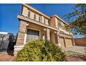 Two-story house with stone accents and a three-car garage at 5728 Collier Falls Ave, Las Vegas, NV 89139