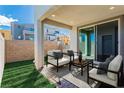 Cozy backyard patio with seating area and green lawn at 642 Angel Aura St, Las Vegas, NV 89138