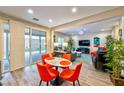 Dining area with a round marble table and orange chairs at 8029 Ancient Oaks Ave, Las Vegas, NV 89113