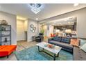 Open-concept living room with view of kitchen and dining area at 8029 Ancient Oaks Ave, Las Vegas, NV 89113