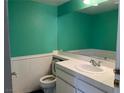 Bathroom with teal walls, white vanity, and toilet at 127 Coventry Cir, Henderson, NV 89074