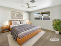 Virtually staged main bedroom with a king-size bed, nightstands, and a large window at 2224 Fountain Valley Way, North Las Vegas, NV 89031