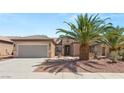 Charming single-story home with a tiled roof, attached garage, and desert landscaping at 2245 Canyonville Dr, Henderson, NV 89044