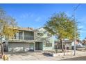 Front exterior view of a two-story home with a balcony and attached garage at 401 Altamira Rd, Las Vegas, NV 89145