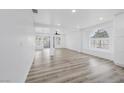 Open living area with wood-look flooring, white walls, and recessed lighting at 8979 Green Jade Dr, Las Vegas, NV 89129