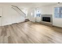 Living room with wood-style flooring, white walls, and a staircase at 2608 Matogroso Ln, Las Vegas, NV 89121