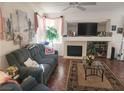 Living room with tile floors, a fireplace, ceiling fan, and large windows at 6409 Sierra Diablo Ave, Las Vegas, NV 89130