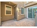 Private patio with brick pavers adjacent to the home's entrance at 7132 Weavers Pl, North Las Vegas, NV 89084