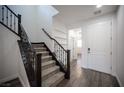 Bright entryway with hardwood floors, built-in shelving, and a white door at 12241 Regal Springs Ct, Las Vegas, NV 89138