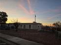 Single-story home with carport, chain-link fence, and desert landscaping at 158 Copper St, Henderson, NV 89015