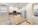 Modern kitchen with white cabinets, stainless steel appliances, and a large island at 5372 Polo Grounds St, Las Vegas, NV 89148