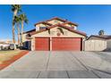 Two story house with a three car garage and landscaped yard at 164 Herbie Ln, Henderson, NV 89015