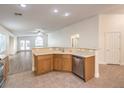 Kitchen with island, stainless steel appliances, and light wood cabinets at 2287 Dakota Sky Ct, Henderson, NV 89052