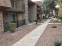 Apartment building exterior walkway lined with plants at 5152 River Glen Dr # 465, Las Vegas, NV 89103