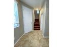 Tiled entryway with front door, staircase, and coat closet at 5358 Panaca Spring St, Las Vegas, NV 89122