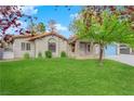 Charming house with stone accents and a well-maintained lawn at 3159 Vistoso Cir, Henderson, NV 89014